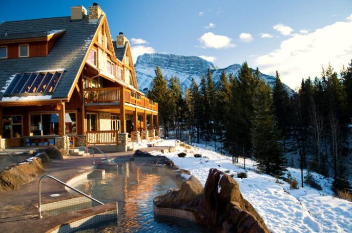 Buffalo Mountain Lodge exterior surrounded by forest and mountain views in Banff